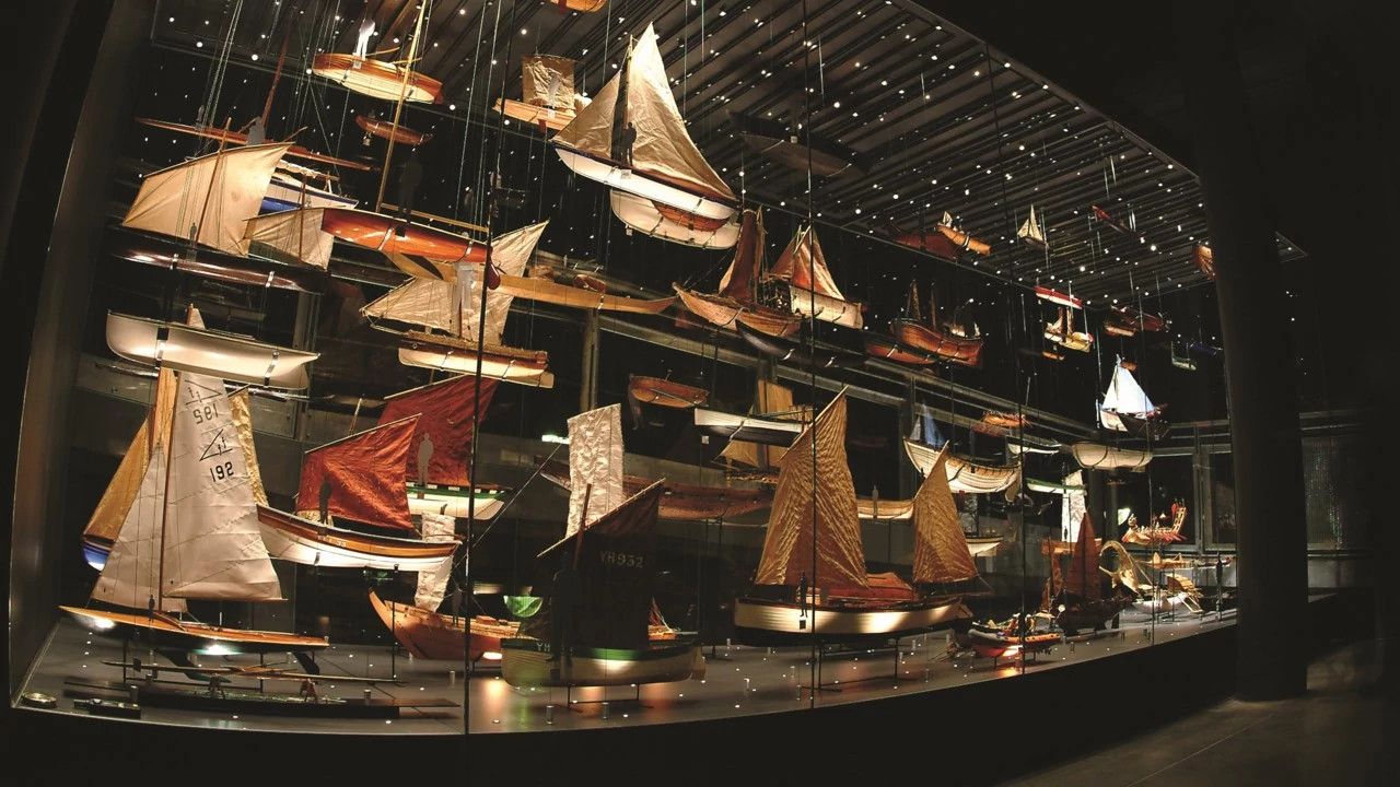 Boat models in large glass exhibit case