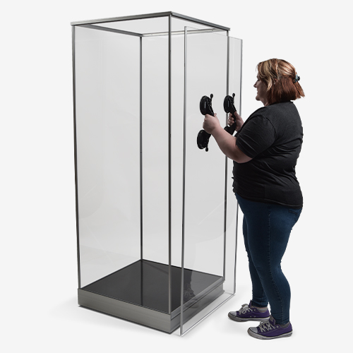 Person removing single panel from side of tower exhibit case