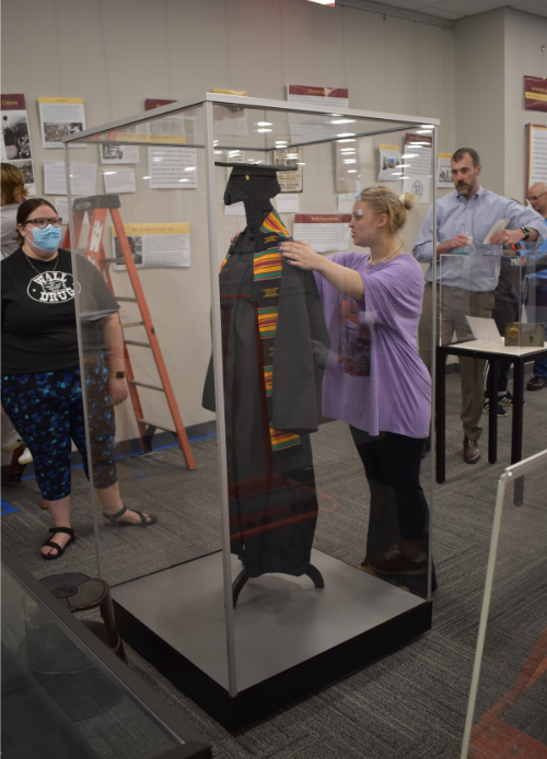 Students from Dr. Kieran's class installing a textile in a Gaylord Archival mannequin case